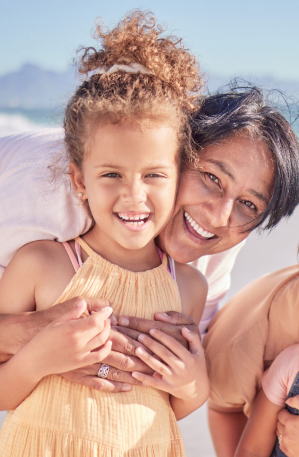 Young woman hugging little girl
